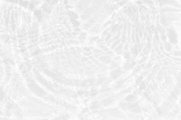 White water with ripples on the surface. Defocus blurred transparent white colored clear calm water surface texture with splashes and bubbles. Water waves with shining pattern texture background.