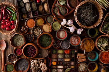 Spices. Collection of spices in bowls on wooden rustic table forming an abstract background.