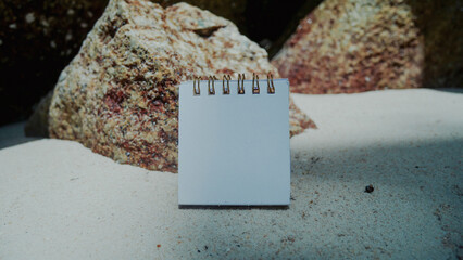 Mockup business paper card on beach sand background.