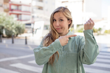 pretty woman looking impatient and angry, pointing at watch, asking for punctuality, wants to be on...