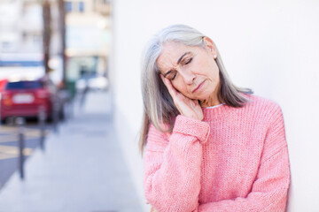 senior retired pretty white hair woman feeling bored, frustrated and sleepy after a tiresome, dull...