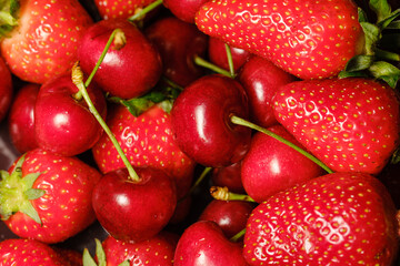 red ripe strawberries and cherries close-up