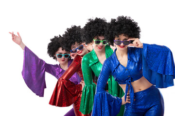 A group of girls in colorful flared suits and afro wigs pose against a white background. Disco style from the eighties or seventies.