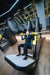 Sporty lady training in sportswear. Young woman working out in the gym.