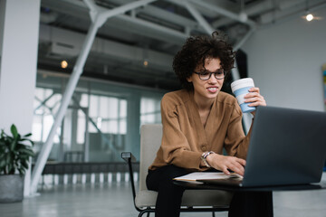 Fototapeta premium Millennial businesswoman work on laptop in office
