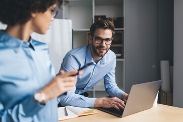 Millenial business man and woman working in office