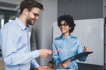 Millenial business man and woman working in office