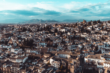 Aerial view of Albayzín, Granada: A captivating tapestry of winding streets, white houses, and the majestic Alhambra, creating a spellbinding panorama.