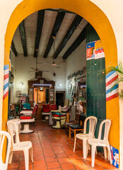 Old Barbershop retro caribbean colorful boutique in Cuba