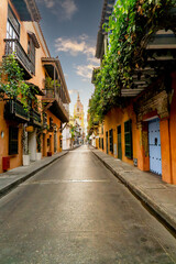 Fototapeta na wymiar Vertical photo of Cartagena street in colombia with church and colonial balcony in old city 