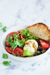 Vegetable salad with egg and whole grain toast for breakfast, white background.