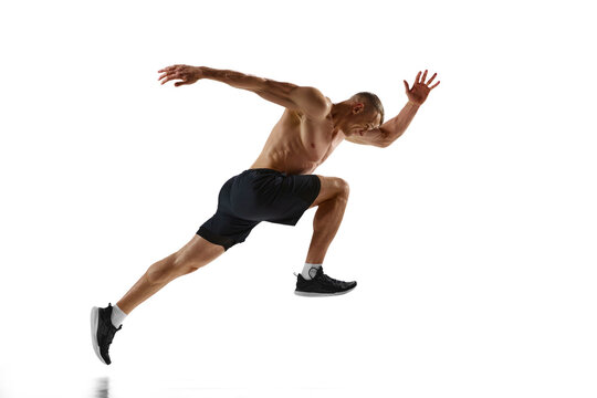 Endurance. Dynamic image of professional sportsman, shirtless muscular man in motion, running, training against white studio background