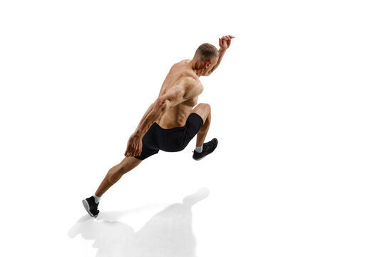 Relief body. Top view image of man, professional runner, athlete in motion against white studio background with shadow on floor