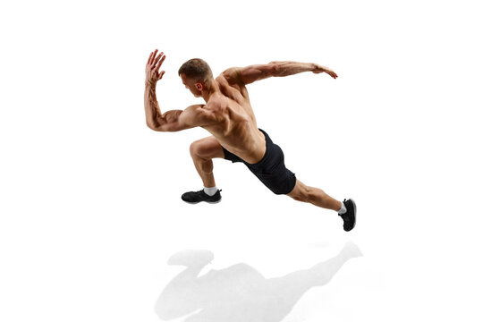 Shirtless sportsman. Top view image of man, professional runner, athlete in motion against white studio background with shadow on floor