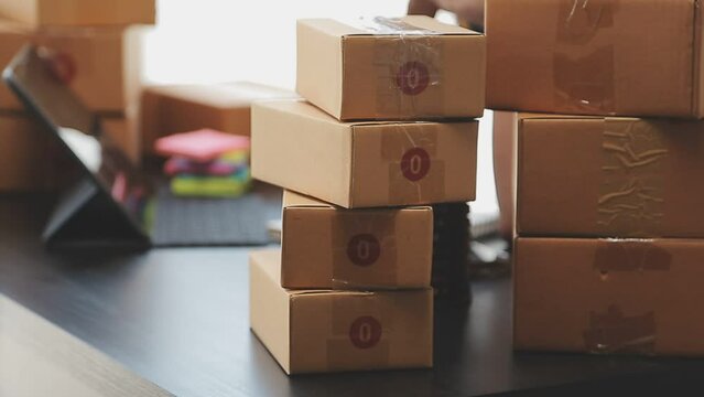 Business woman start up small business entrepreneur SME success .freelance woman working at home with Online Parcel delivery. SME and packaging deliveryconcept