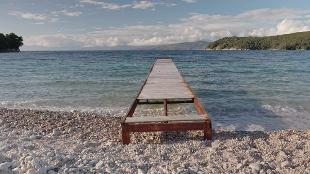 wooden pier on beach in corfu greece