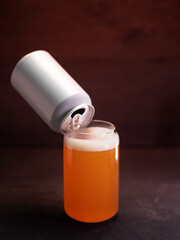 craft beer glass , aluminum can . wooden background