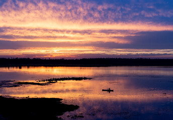 Obraz na płótnie Canvas Sunset over water body