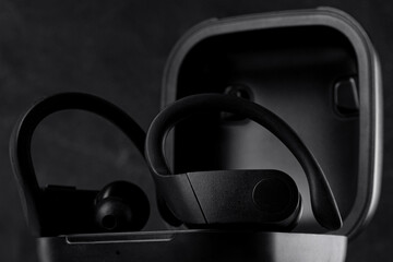 Fototapeta na wymiar wireless headphones with black background