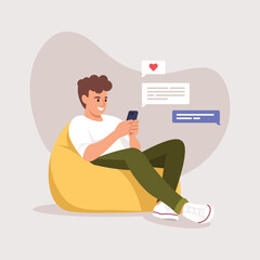 a man (boy) sitting in a bag chair and texting a girl