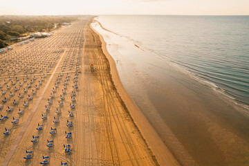 Morning on the still deserted beach. Umbrella beach for relaxing and sun set beach. Bibione, Italy © Zedspider