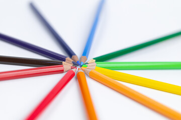 Fototapeta premium Circle of colored pencils on a white background. colorful and brightness concept. Pride Month. gender diversity. cultural diversity. free space for advertising. backdrop for advertising.