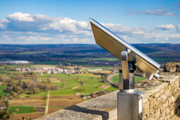 A telescope is located on the observation deck of the Hohenwil castle overlooking the city of...