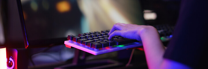 Female cyber hacker gamer pressing on keyboard to competition and playing games on computer
