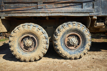 Fototapeta na wymiar A wheel from a big truck in the coming. Off-road traffic.