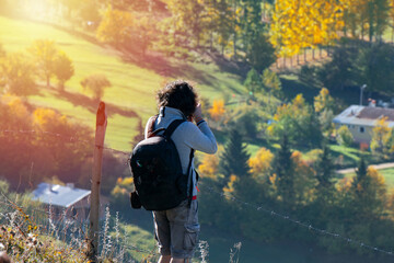 Young man traveler looking and photographing beautiful autumn in Turkey, Travel lifestyle concept.