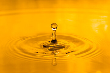 yellow drop oil , Liquid gold oil drop ripple background.