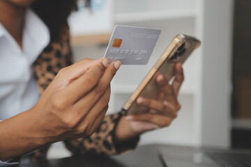 Women holding credit card and using smartphones at home.Online shopping, internet banking, store...