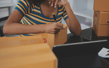 Business woman start up small business entrepreneur SME success .freelance woman working at home with Online Parcel delivery. SME and packaging deliveryconcept