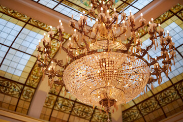 crystal chandelier, close-up photo. Crystal chandelier in the interior. The glass figurines on the...