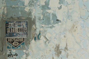 pastel light blue wall with ad in chinese and numbers in Taiwan