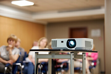 Screen projector. the projector is showing video. digital video projector on a stand, rear view....