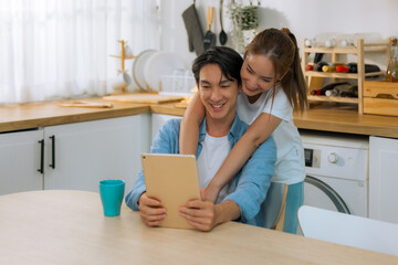 Married couples spend a few tender minutes before staring their workday. Sharing, laughing, teasing, serving each other loaf and beverage, Mutual understanding, sympathy and a supportive life partner