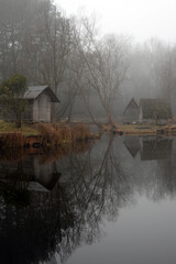 Landscape of a beautiful fishing lake. Winter morning, a mist on the lake.