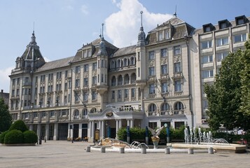 Fototapeta premium Debrecen, Hungary - Jun 18, 2023: A walking in the center of Debrecen city in northeastern Hungary in a sunny spring day. Grand Hotel Aranybika. Selective focus.
