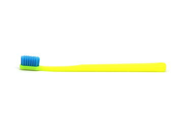 Yellow toothbrush with blue bristles isolated on white