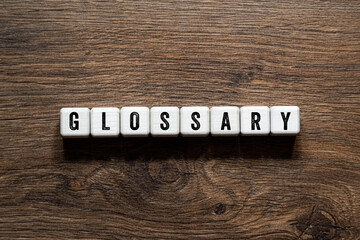 Glossary - word concept on building blocks, text