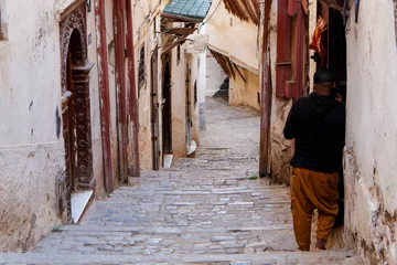 Keuken foto achterwand Empire State Building Street scene in the Casbah of Algiers (Alger), Algeria. Stone stairs and ancient ottoman houses. Man waiting at a house door.