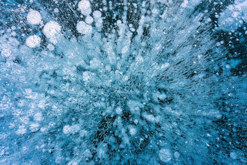 Natural ice bubbles on frozen lake in wintertime