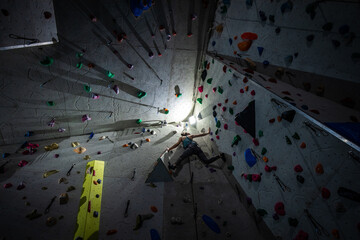Climbing walls and boulder center. Extreme sport requiring strength and agility. People climbing