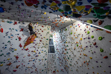 Climbing walls and boulder center. Extreme sport requiring strength and agility. People climbing
