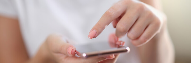 Woman hands touch screen of smartphone closeup