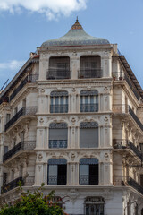 Typical French colonial white facade of a residential building in Algiers (Alger), Algeria. Renaissance 19th century style with loggias and balconies.