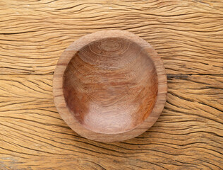 Empty handmade wooden bowl over wooden table