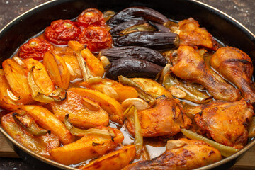 front close view cooked vegetables such as potatoes tomatoes and eggplants inside pan on the brown background vegetable meal dinner food