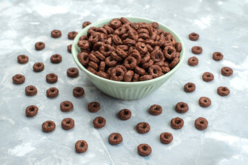 front view chocolate cereals inside green plate on the blue background cacao breakfast food cereals health